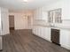 Kitchen boasts white cabinets, stainless steel appliances, and wood-look floors at 1853 Edington Sw Rd, Marietta, GA 30064