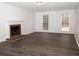 Living room with hardwood floors, fireplace and large windows at 1853 Edington Sw Rd, Marietta, GA 30064