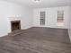 Living room with hardwood floors, fireplace and large windows at 1853 Edington Sw Rd, Marietta, GA 30064