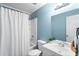 Clean bathroom with light blue walls, white vanity, and shower/tub at 2107 Seavey Dr, Decatur, GA 30032