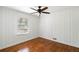 Simple bedroom with hardwood floors, window, and ceiling fan at 2107 Seavey Dr, Decatur, GA 30032