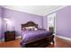 Purple walls and hardwood floors in this spacious bedroom at 3280 Stillhouse Se Ln # 410, Atlanta, GA 30339