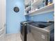 Laundry room with washer, dryer, and storage shelves at 3280 Stillhouse Se Ln # 410, Atlanta, GA 30339