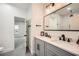 Bathroom featuring a dual vanity with quartz countertop and a framed mirror with modern sconces at 4322 Timberland Sw Dr, Lilburn, GA 30047