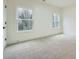 Neutral bedroom features plush carpeting and natural light from two windows at 4322 Timberland Sw Dr, Lilburn, GA 30047