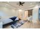 Spacious bedroom features a ceiling fan, tray ceiling, light hardwood floors and stylish barn door to the bath at 4322 Timberland Sw Dr, Lilburn, GA 30047