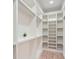 Well-organized walk-in closet with shelving and hardwood floors, offering plenty of storage space at 4322 Timberland Sw Dr, Lilburn, GA 30047