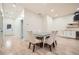 Dining room with modern light fixtures, wood floors and white dining chairs at 4322 Timberland Sw Dr, Lilburn, GA 30047