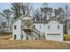 Charming two-story home with board and batten siding, a covered porch, and an attached garage at 4322 Timberland Sw Dr, Lilburn, GA 30047