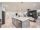 Open kitchen with a large center island, stainless steel appliances, and seamless access to the living area at 4322 Timberland Sw Dr, Lilburn, GA 30047