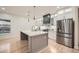 Modern kitchen boasting a large island with stone countertop, stainless appliances, and lots of natural light at 4322 Timberland Sw Dr, Lilburn, GA 30047