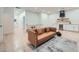 Open-concept living room with hardwood floors, modern sofa, dining area and built-in bar at 4322 Timberland Sw Dr, Lilburn, GA 30047