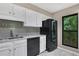 Eat-in kitchen with black appliances and wood look floors at 24214 Plantation Ne Dr, Atlanta, GA 30324