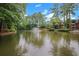 Serene pond with fountain, surrounded by lush greenery and charming buildings at 24214 Plantation Ne Dr, Atlanta, GA 30324