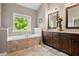 Spa-like bathroom with soaking tub, double vanity, and large mirror at 2741 Prado Ln, Marietta, GA 30066