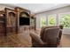 Spacious bonus room with hardwood floors, built-in entertainment center, and leather chairs at 2741 Prado Ln, Marietta, GA 30066