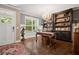 Elegant home office with hardwood floors, built-in shelves, and large windows at 2741 Prado Ln, Marietta, GA 30066