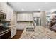 Modern kitchen with white cabinets, granite countertops, and stainless steel appliances at 2741 Prado Ln, Marietta, GA 30066