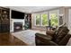 Living room features hardwood floors, fireplace, built-in shelving, and large windows at 2741 Prado Ln, Marietta, GA 30066