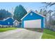 Blue house with a white garage door and a well-maintained lawn at 5752 Riverside Walk Dr, Sugar Hill, GA 30518