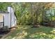 Backyard with green grass and wooded area at 124 Cagle Way, Hiram, GA 30141