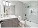 Modern bathroom with gray vanity, white subway tile, and glass shower at 124 Cagle Way, Hiram, GA 30141