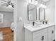 Double vanity bathroom with white cabinets and black accents at 124 Cagle Way, Hiram, GA 30141