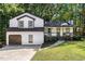 Two-story house with white siding, dark trim, and a two-car garage at 124 Cagle Way, Hiram, GA 30141