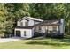 Two-story house with white siding, dark trim, and a two-car garage at 124 Cagle Way, Hiram, GA 30141