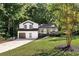 Two-story house with white siding, dark trim, and a two-car garage at 124 Cagle Way, Hiram, GA 30141