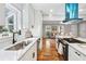 Modern kitchen with white cabinets and a farmhouse sink at 124 Cagle Way, Hiram, GA 30141