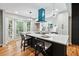 Open concept kitchen with white cabinets and a blue vent hood at 124 Cagle Way, Hiram, GA 30141