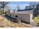 Rear view of house showcasing gray siding, large windows, and a sloping yard at 1276 Westover Nw Trce, Acworth, GA 30102