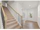 Modern staircase with metal railing and carpeted steps at 7083 Brushwood Bend (Lot 52), Lithonia, GA 30058