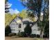 Two-story house with stucco siding, landscaping, and a tree-lined yard at 2080 Milfield Cir, Snellville, GA 30078