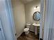 Powder room with pedestal sink and oval mirror at 3964 Riverchess Lot 157 Dr, Atlanta, GA 30331