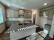 Modern kitchen with granite countertops and gray cabinets at 3964 Riverchess Lot 157 Dr, Atlanta, GA 30331