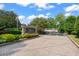 Condominium entrance with a stone sign and landscaping at 6940 Roswell Rd # 24E, Sandy Springs, GA 30328