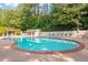 Community swimming pool with lounge chairs and pergola at 6940 Roswell Rd # 24E, Sandy Springs, GA 30328