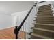 Elegant staircase with hardwood floors and black railing at 6940 Roswell Rd # 24E, Sandy Springs, GA 30328