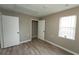 This bedroom features a closet, luxury vinyl plank flooring, and a window at 967 Metropolitan Sw Pkwy, Atlanta, GA 30310