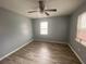 Bedroom with gray walls, wood-look flooring, and a ceiling fan at 967 Metropolitan Sw Pkwy, Atlanta, GA 30310