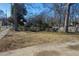 Large front yard with mature trees and a paved driveway at 967 Metropolitan Sw Pkwy, Atlanta, GA 30310