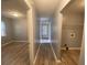 Hallway with gray walls and wood-look flooring, laundry area visible at 967 Metropolitan Sw Pkwy, Atlanta, GA 30310