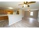 Kitchen with white appliances, wood cabinets, breakfast bar, and open access to living areas at 967 Metropolitan Sw Pkwy, Atlanta, GA 30310