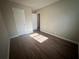 Bedroom with dark brown wood-look flooring and a window at 1168 Dogwood Nw Ct, Conyers, GA 30012