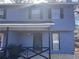 Two-story light blue house with a covered porch and small yard at 1168 Dogwood Nw Ct, Conyers, GA 30012