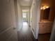Bright hallway with laminate flooring, leading to bedrooms and bathroom at 1168 Dogwood Nw Ct, Conyers, GA 30012