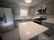 Modern kitchen with gray cabinets, quartz countertops, and stainless steel appliances at 1168 Dogwood Nw Ct, Conyers, GA 30012
