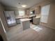 Modern kitchen with gray cabinets, quartz countertops, and island at 1168 Dogwood Nw Ct, Conyers, GA 30012